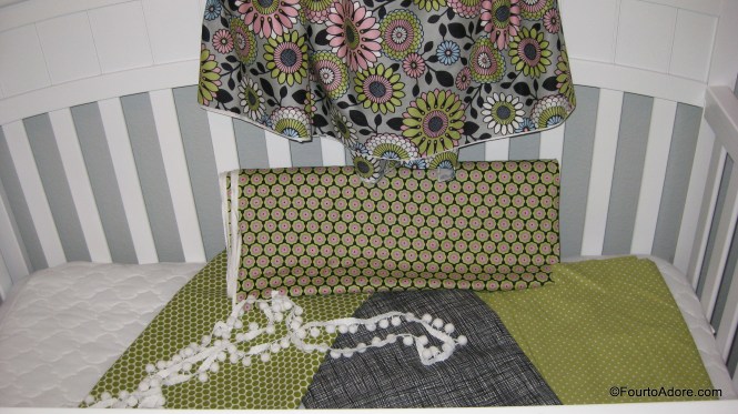 These are the girls fabric swatches. The bold floral was for their curtains and the white pom poms served as embellishments. The smaller floral print is their dust ruffle material and the black flannel and Swiss dot print were for their crib sheets.