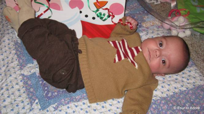 Mason is finding dexterity in his hands and enjoys grabbing everything within reach then trying to munch it.  Here he's gotten some ribbon.