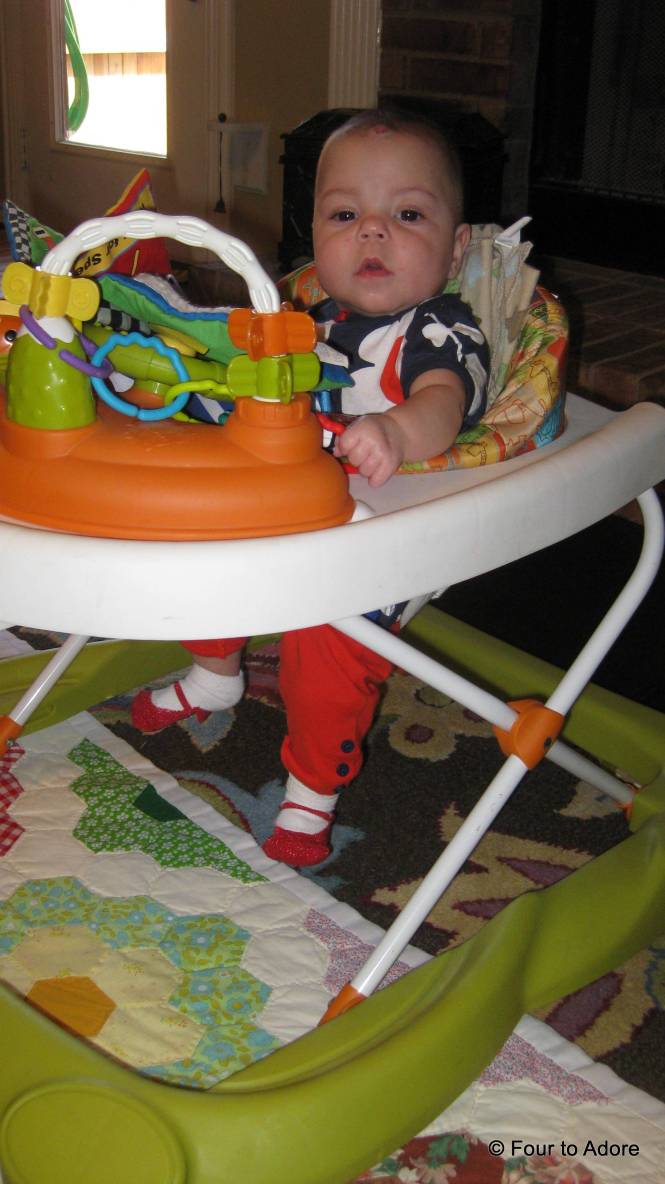 Sydney loves to stand, but poor baby can't reach the floor in these standing toys.