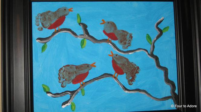 This is my favorite piece of baby art so far.  We used the babies' footprints to make robins for spring.