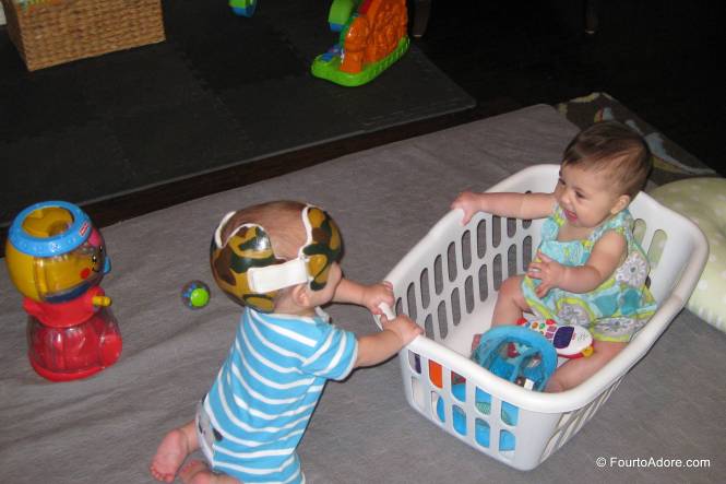 Now that babies are sitting mostly independently, we've had an increasing number of head bonks and crashes.  I put them in laundry baskets with a few toys to help catch them.  It was a great idea until Rylin decided to turn her basket over.  