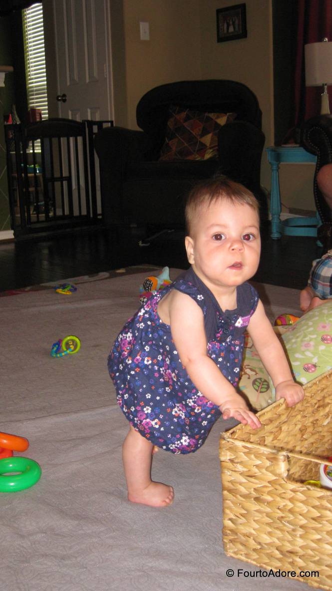 Sydney is finding all sorts of things to pull up on from baskets to siblings.