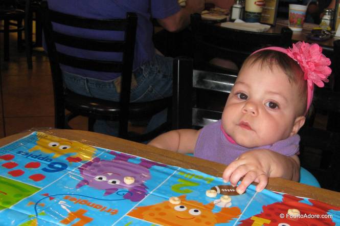 Sydney looked so tiny sitting at the table.  She had to stretch her arms and fingers out just to reach the Cheerios.