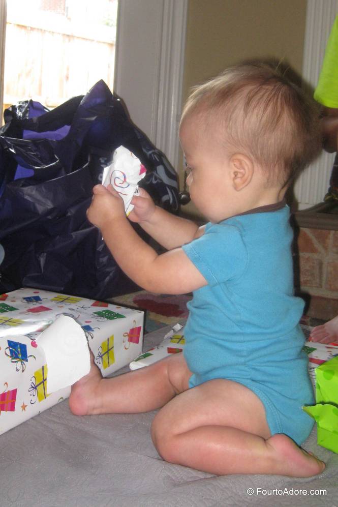 In no time, Mason figured out how to pull the edges off the bright packages.