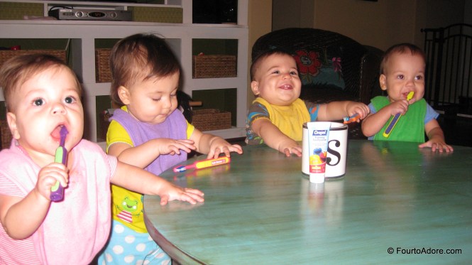 After we brush the babies teeth we let them do the work themselves.  We usually do this while they are still seated in the quad table, but I forgot tonight and wasn't hauling them back in just for teeth brushing.  