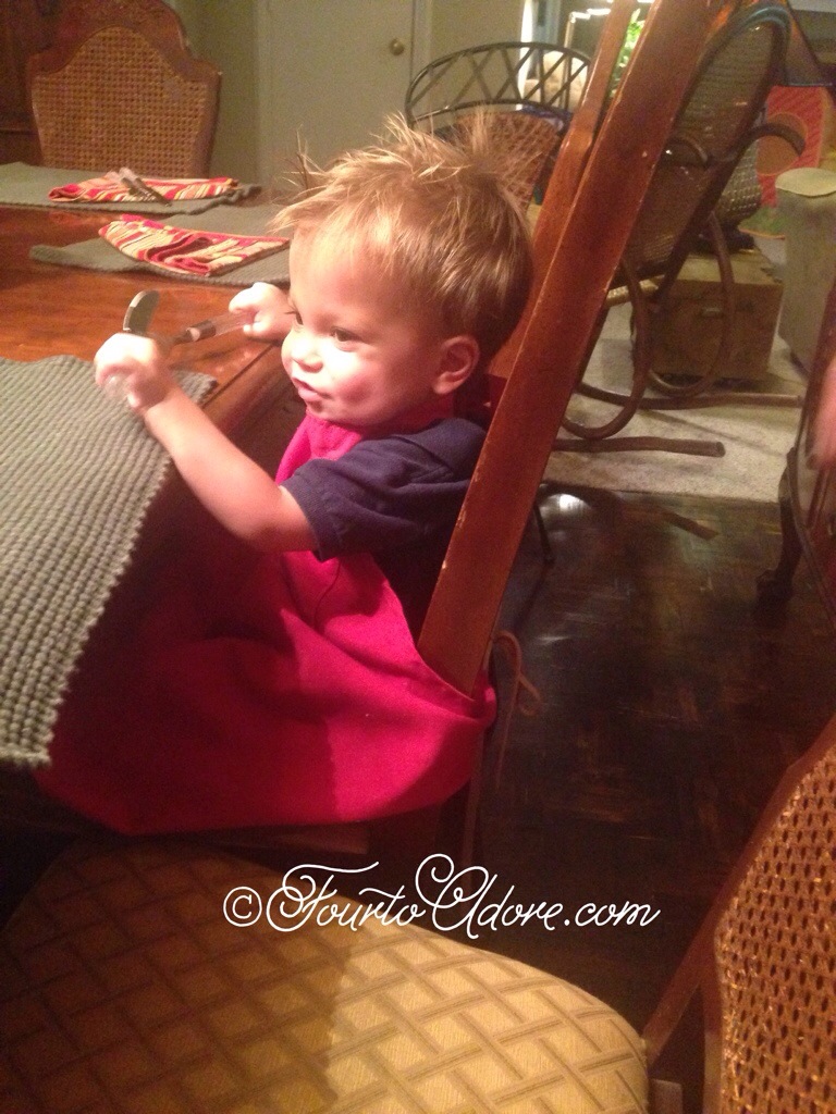 Use an apron and a pillow/ cushion/ phone book to make a booster seat when eating away from home with toddlers.