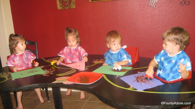 Toddler craft: roll cars through paint to create tracks.  Brown paint looks like mud.  
