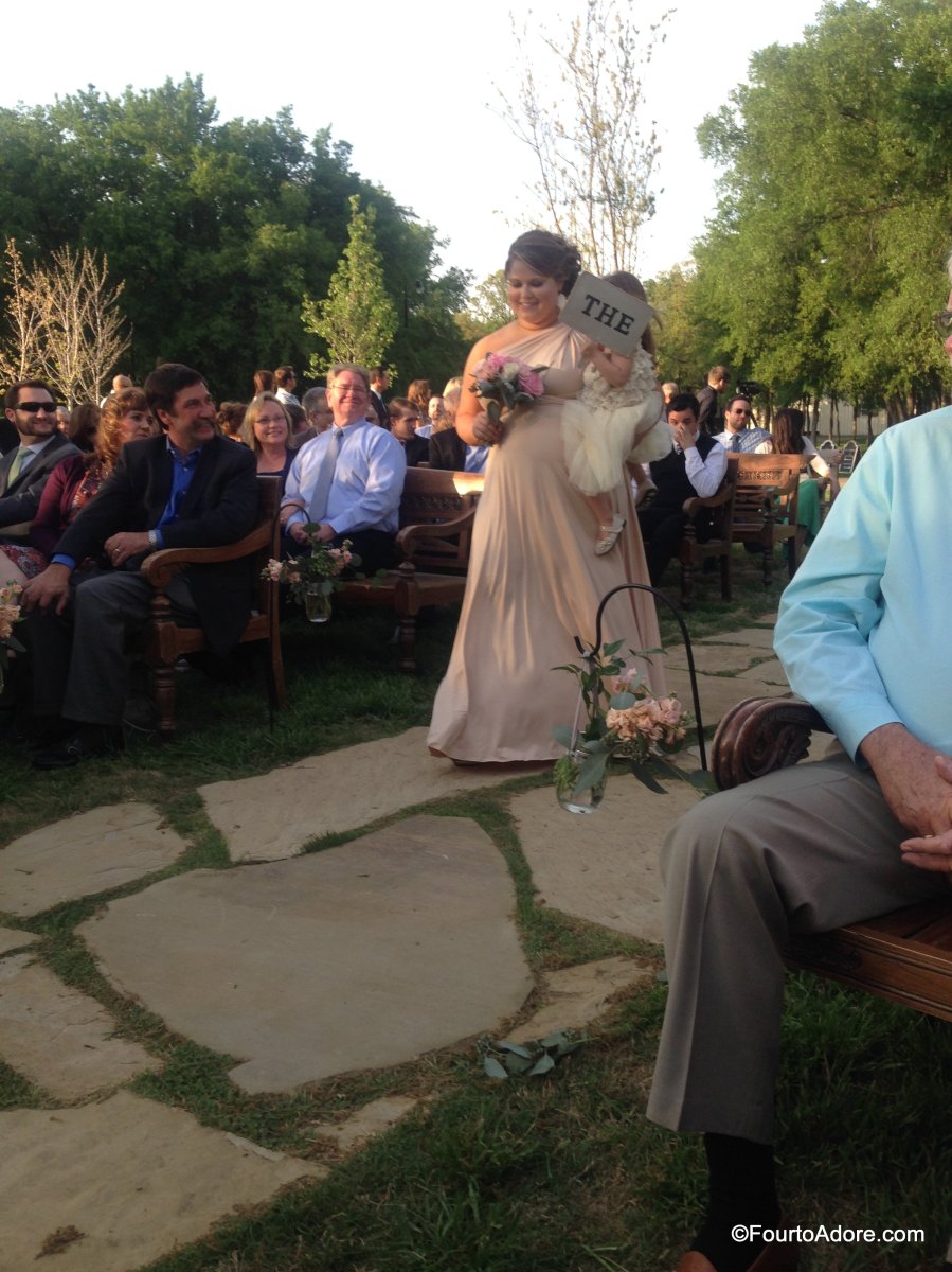 Have flower girls and ring bearers hold signs saying "Here" "Comes" "the" "Bride"